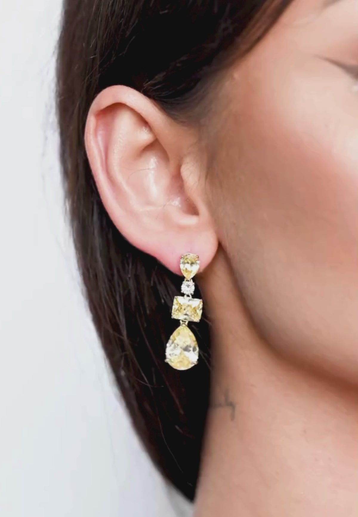 Close-up of the earring worn by a model.