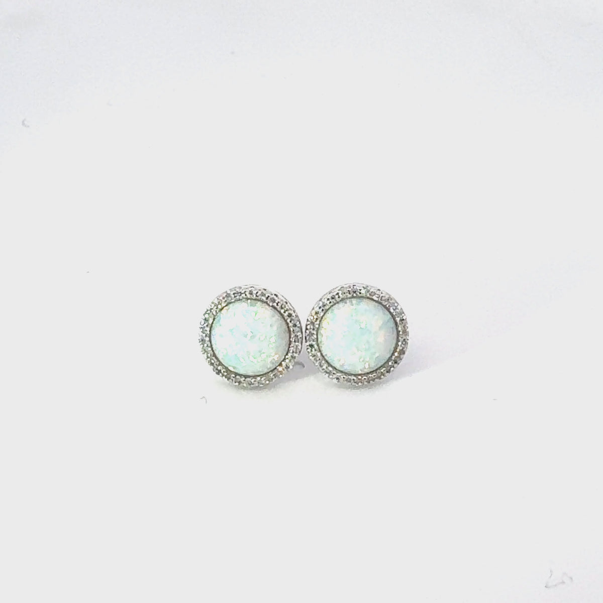 Video of Large Sparkling Halo Opal Stud Earrings Silver, showing the drop, movement and scale from multiple angles.