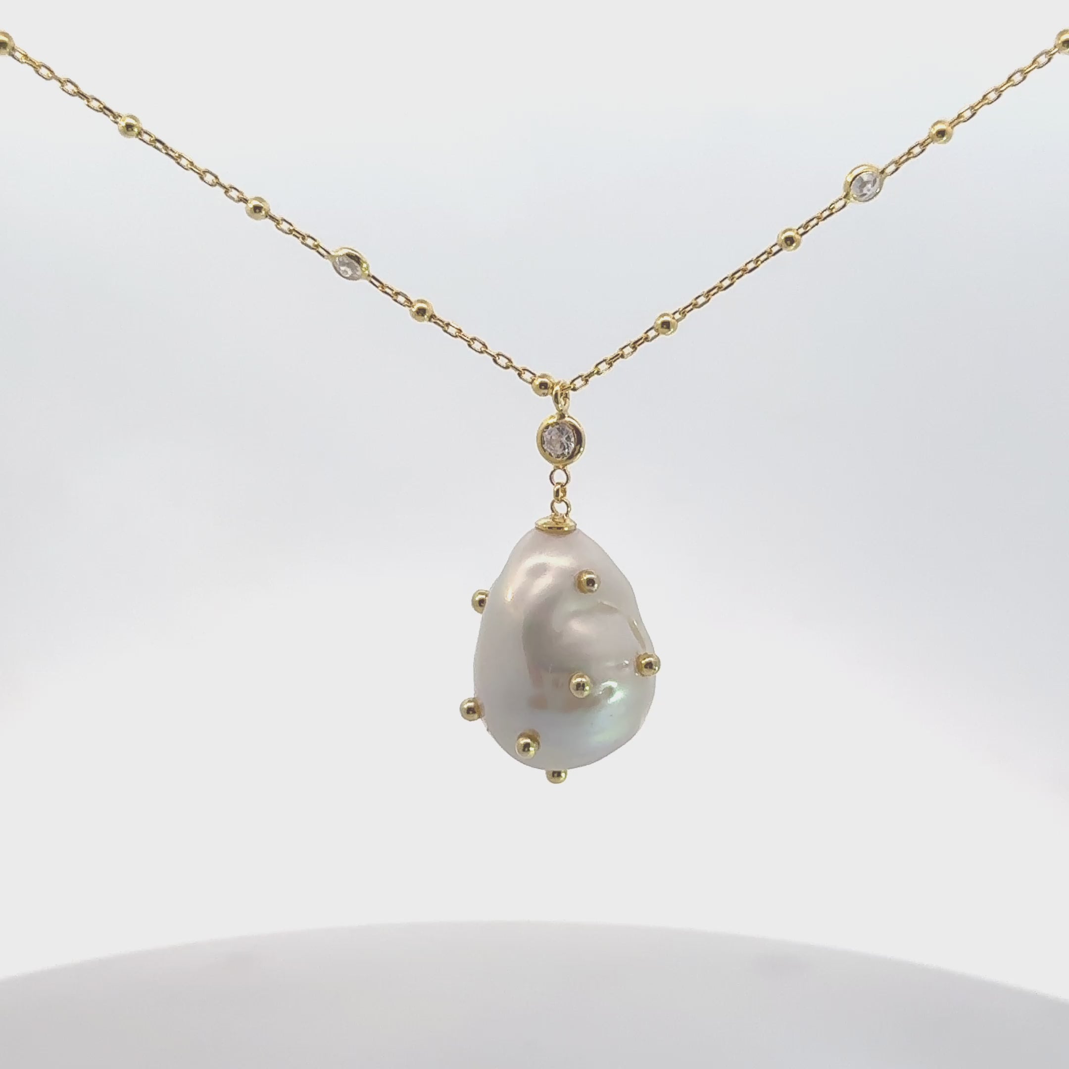 Video of Polka Dot Baroque Pearl Pendant Necklace Gold Cz, showing the pendant, chain and scale from multiple angles.