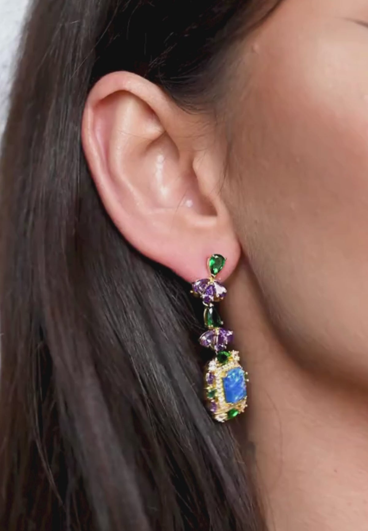 Close-up of the earring worn by a model.
