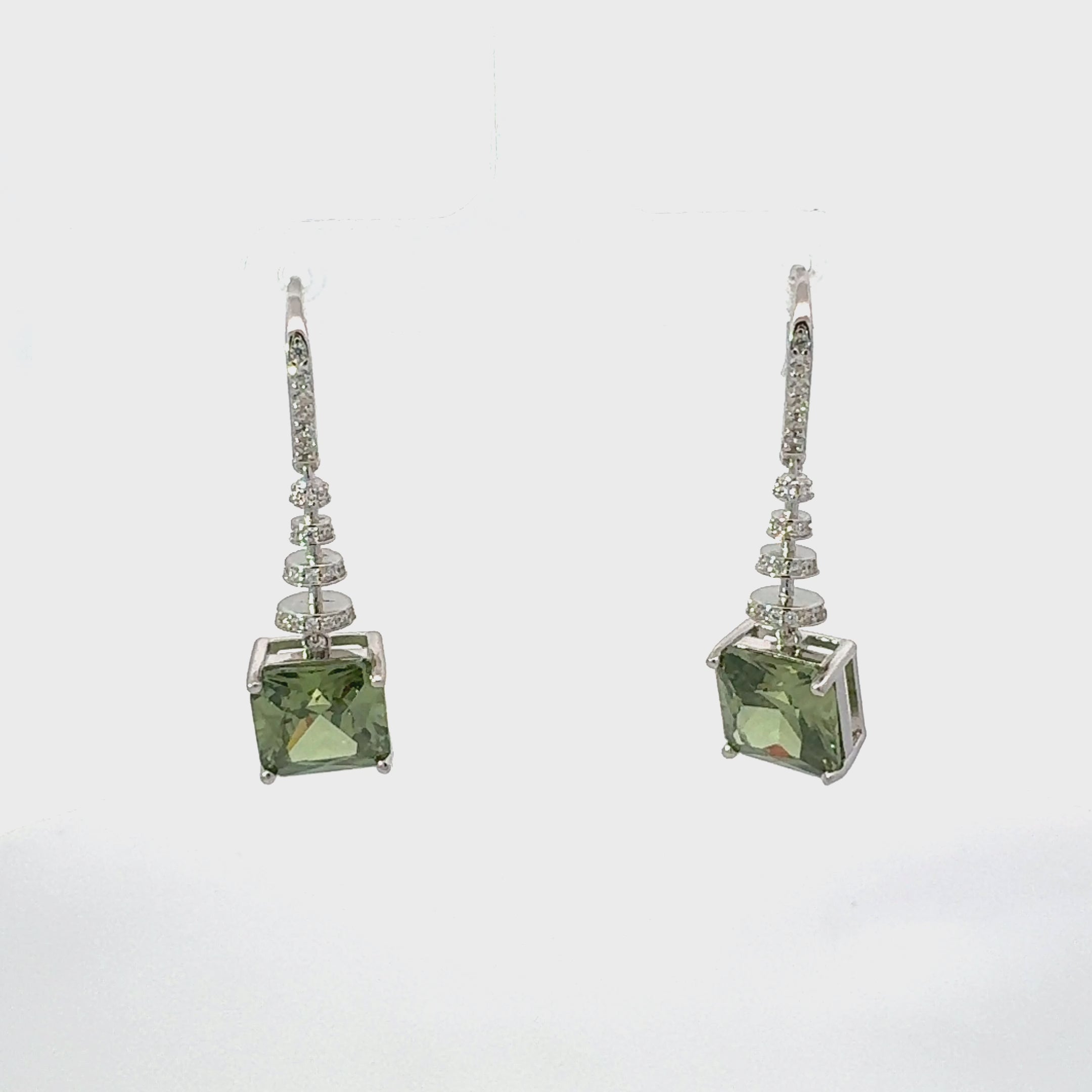 Video of Spiral Square Crystal Drop Earrings Peridot Green Silver, showing the drop, movement and scale from multiple angles.