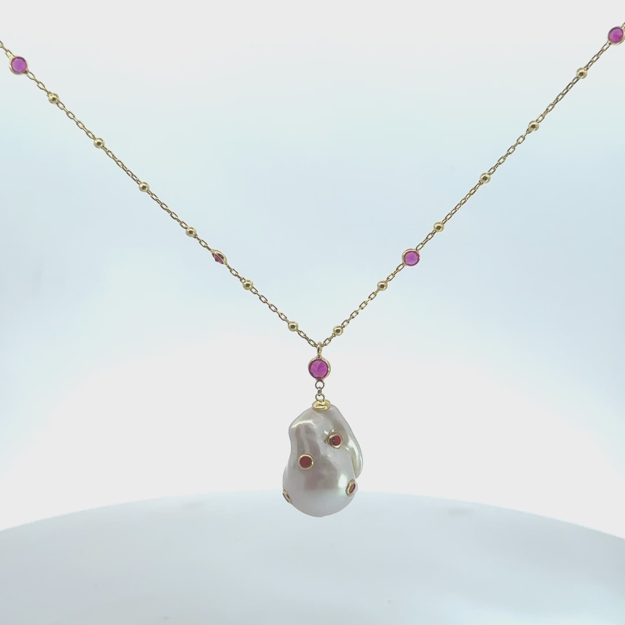 Video of Polka Dot Baroque Pearl Long Necklace Gold Ruby, showing the pendant, chain and scale from multiple angles.