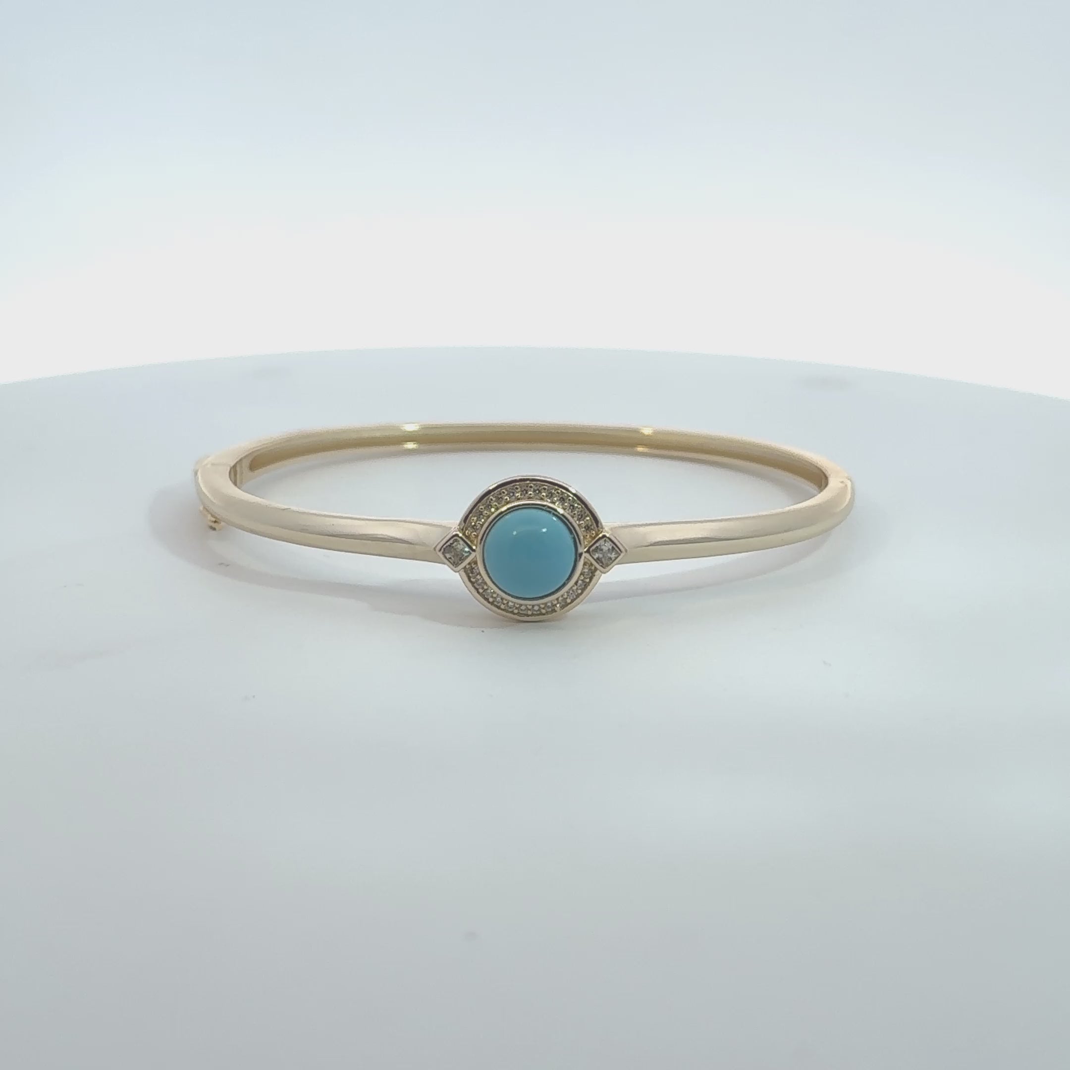 Rotating display of the turquoise stone gold bangle.