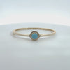 Rotating display of the turquoise stone gold bangle.