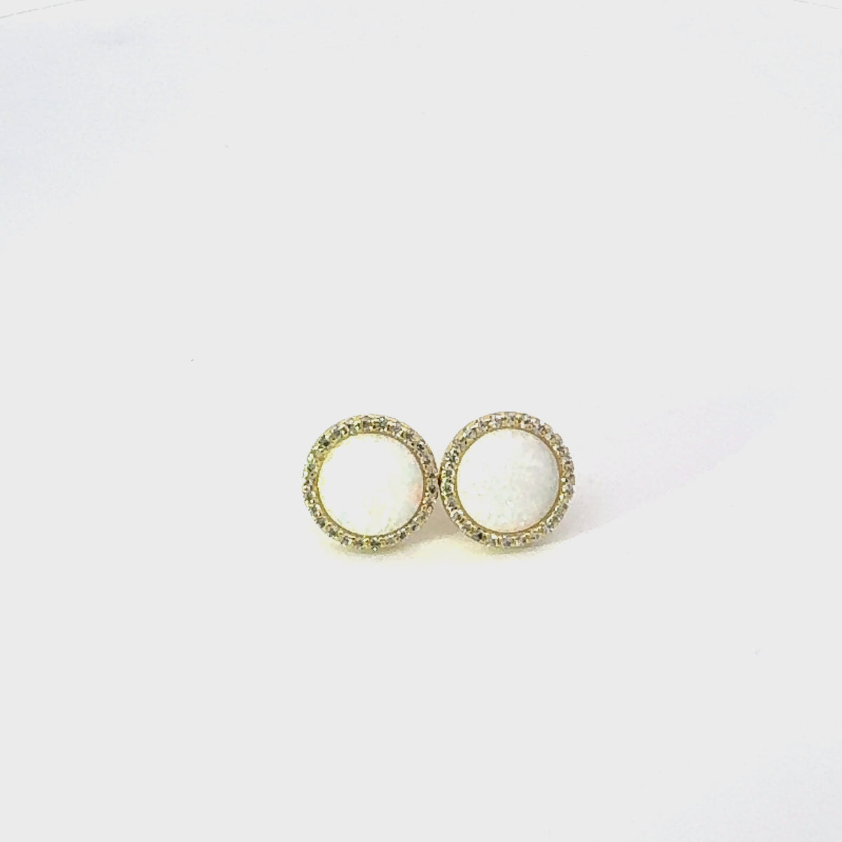 Video of Large Sparkling Halo Opal Stud Earrings Gold, showing the drop, movement and scale from multiple angles.