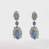 Video of Frida Blue Opal Rainbow Drop Earrings Silver, showing the drop, movement and scale from multiple angles.