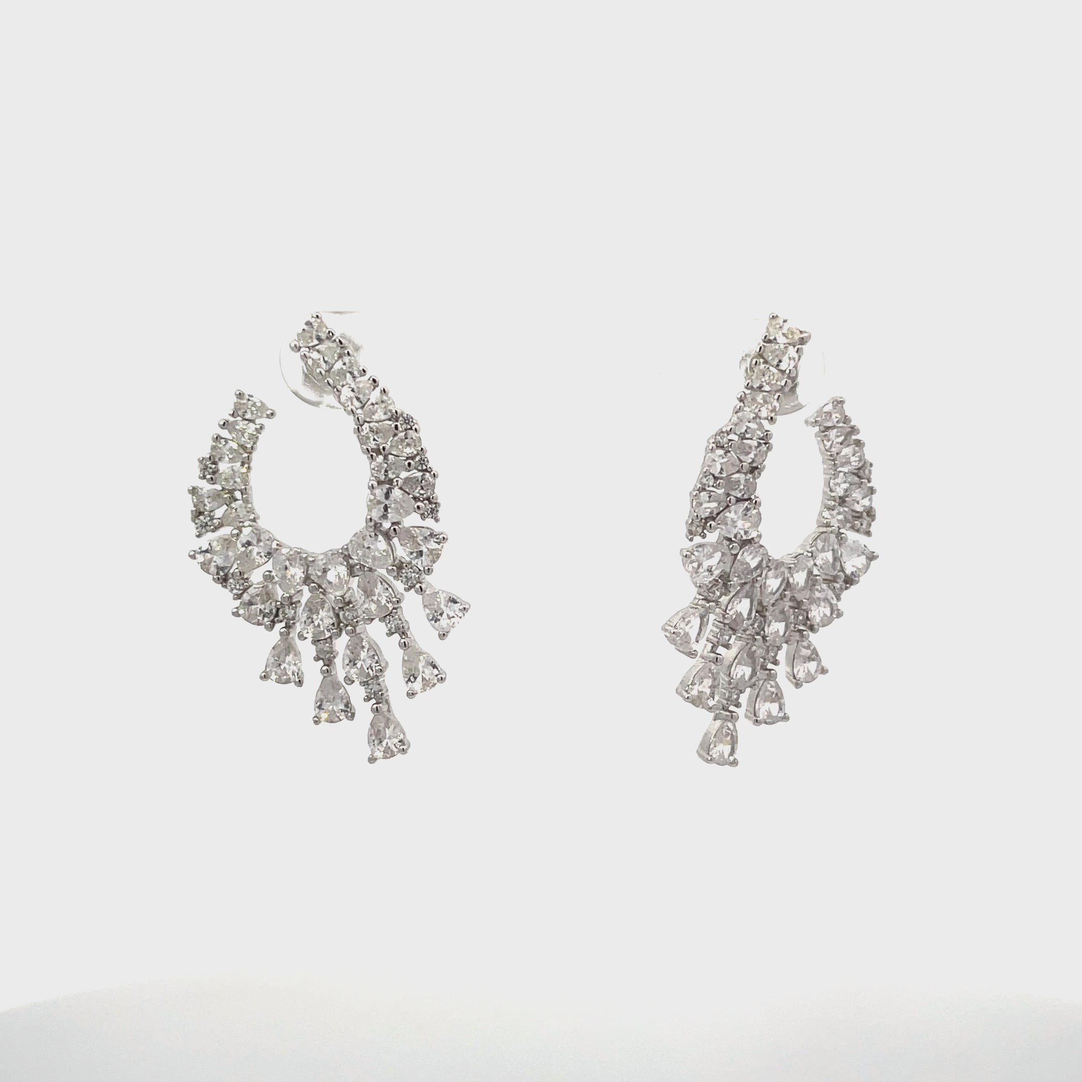 Video of Blazing Flames Hoop Earrings Silver, showing the drop, movement and scale from multiple angles.
