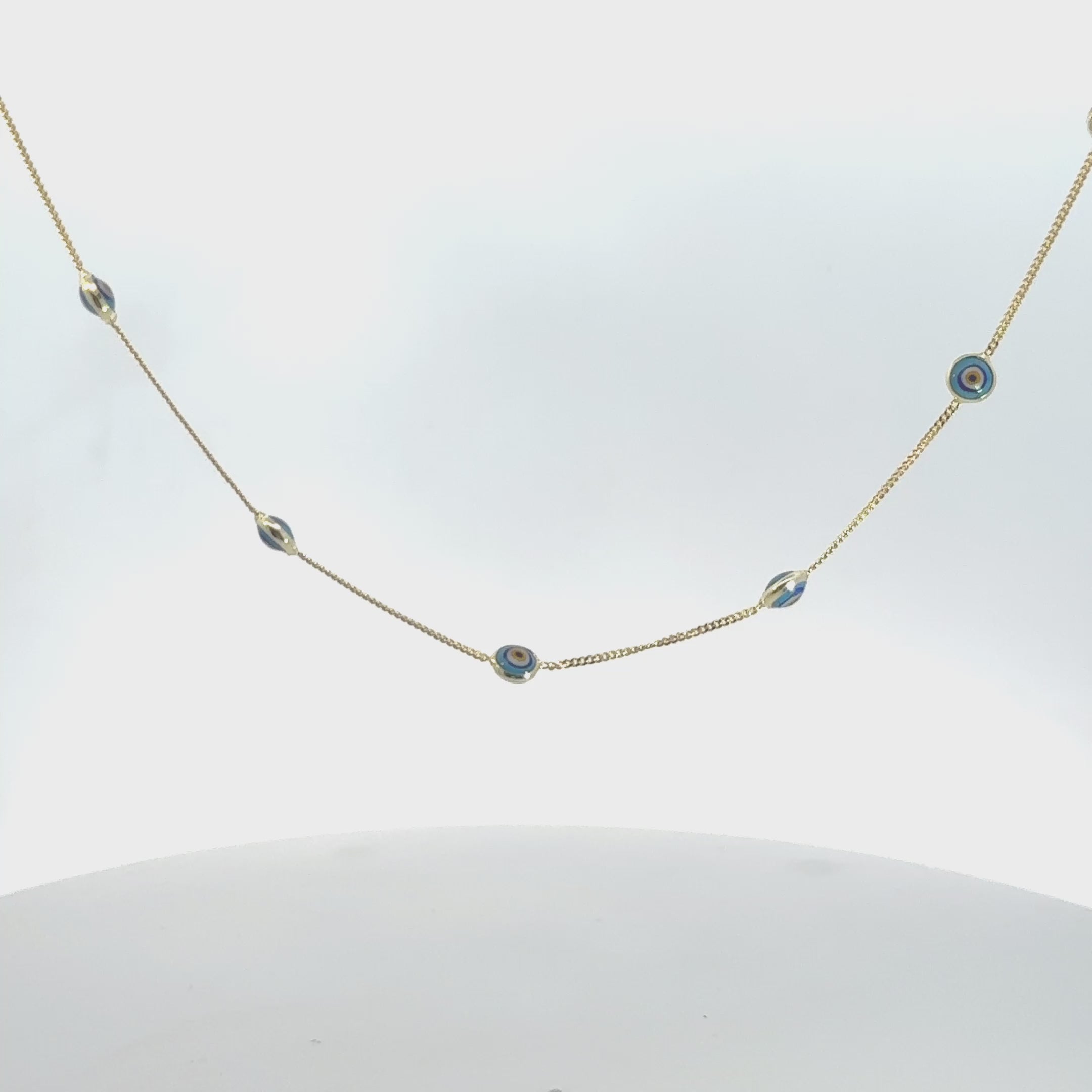 Video of Evil Eye Blue Enamel Choker Necklace Gold, showing the pendant, chain and scale from multiple angles.