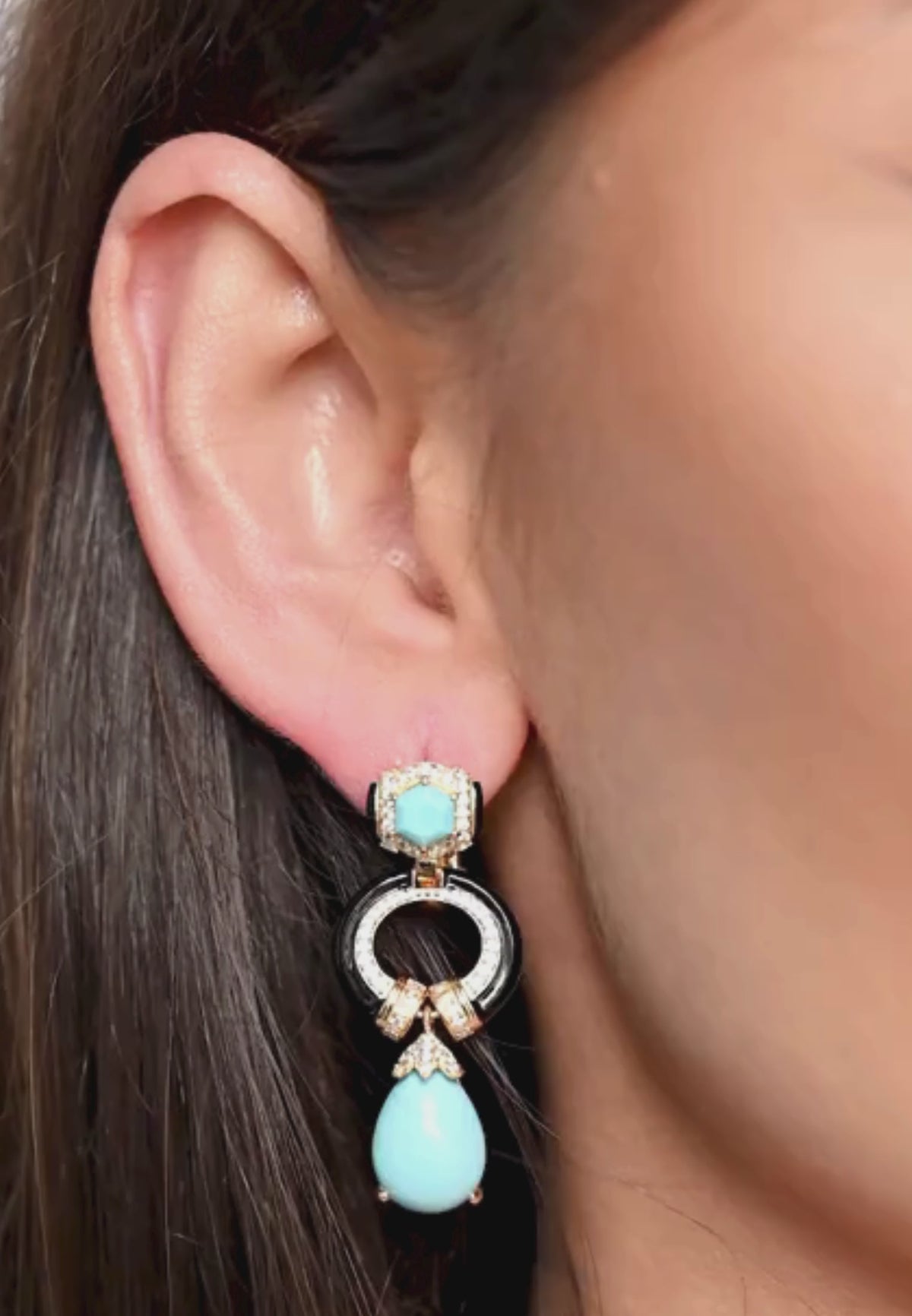 Close-up of the earring worn by a model.