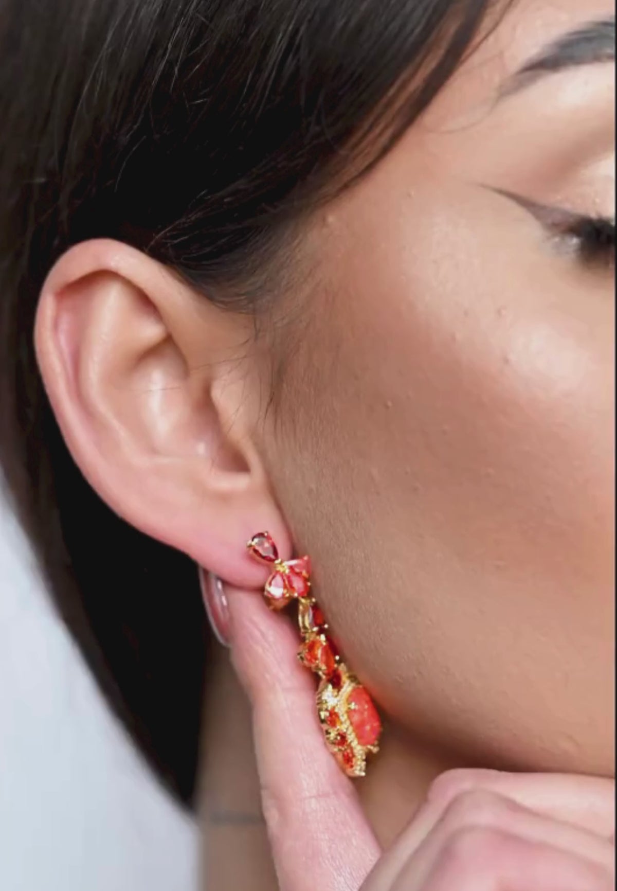 Close-up of the earring worn by a model.