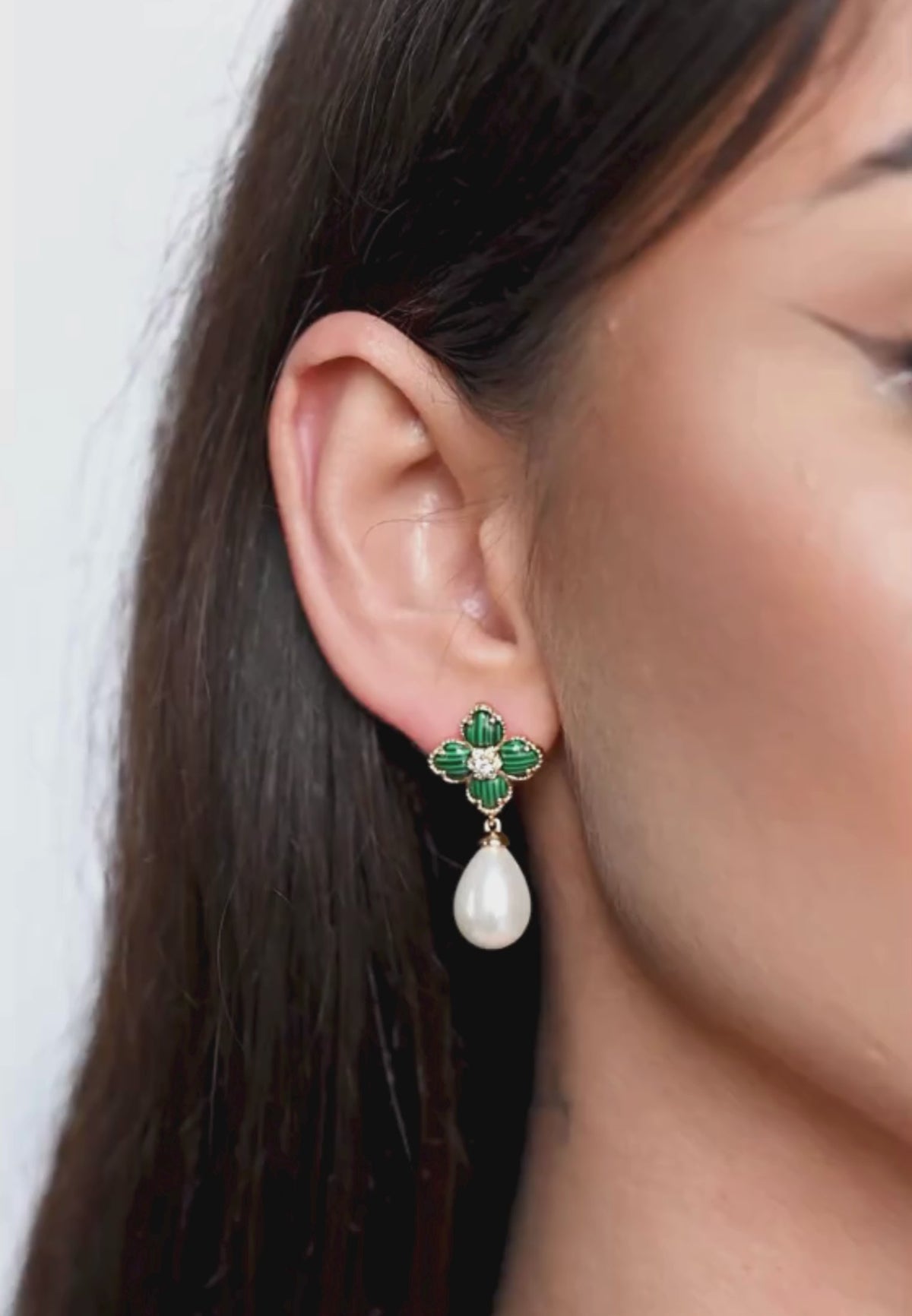 Close-up of the earring worn by a model.