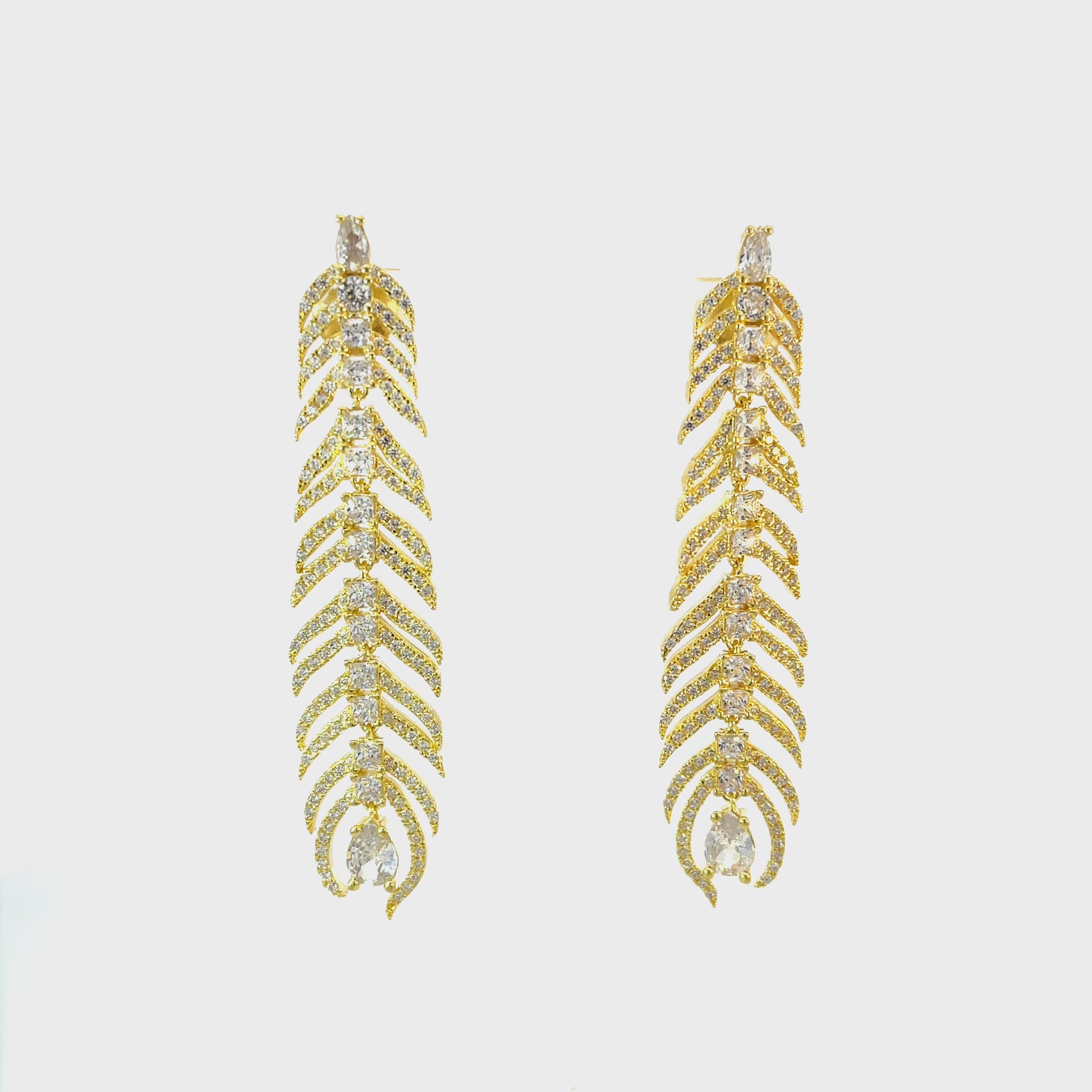 Video of Peacock Feather Elongated Drop Earrings Gold, showing the drop, movement and scale from multiple angles.