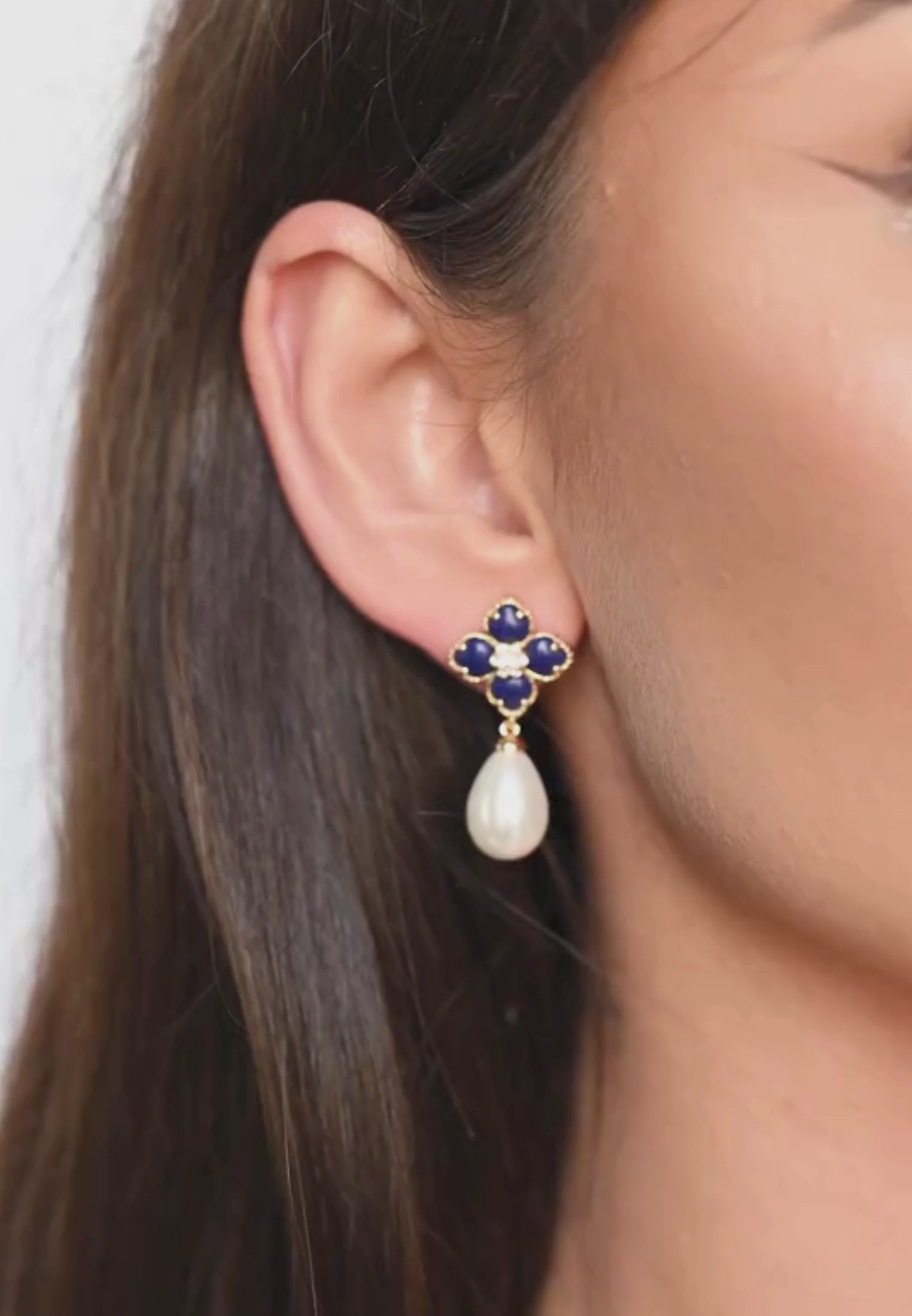 Close-up of the earring worn by a model.
