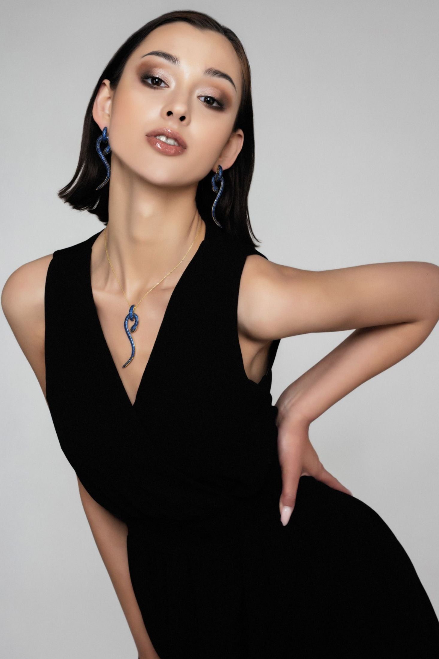 Anaconda Snake Pendant Necklace Gold Sapphire worn by a model, showing the pendant scale and how the chain sits.