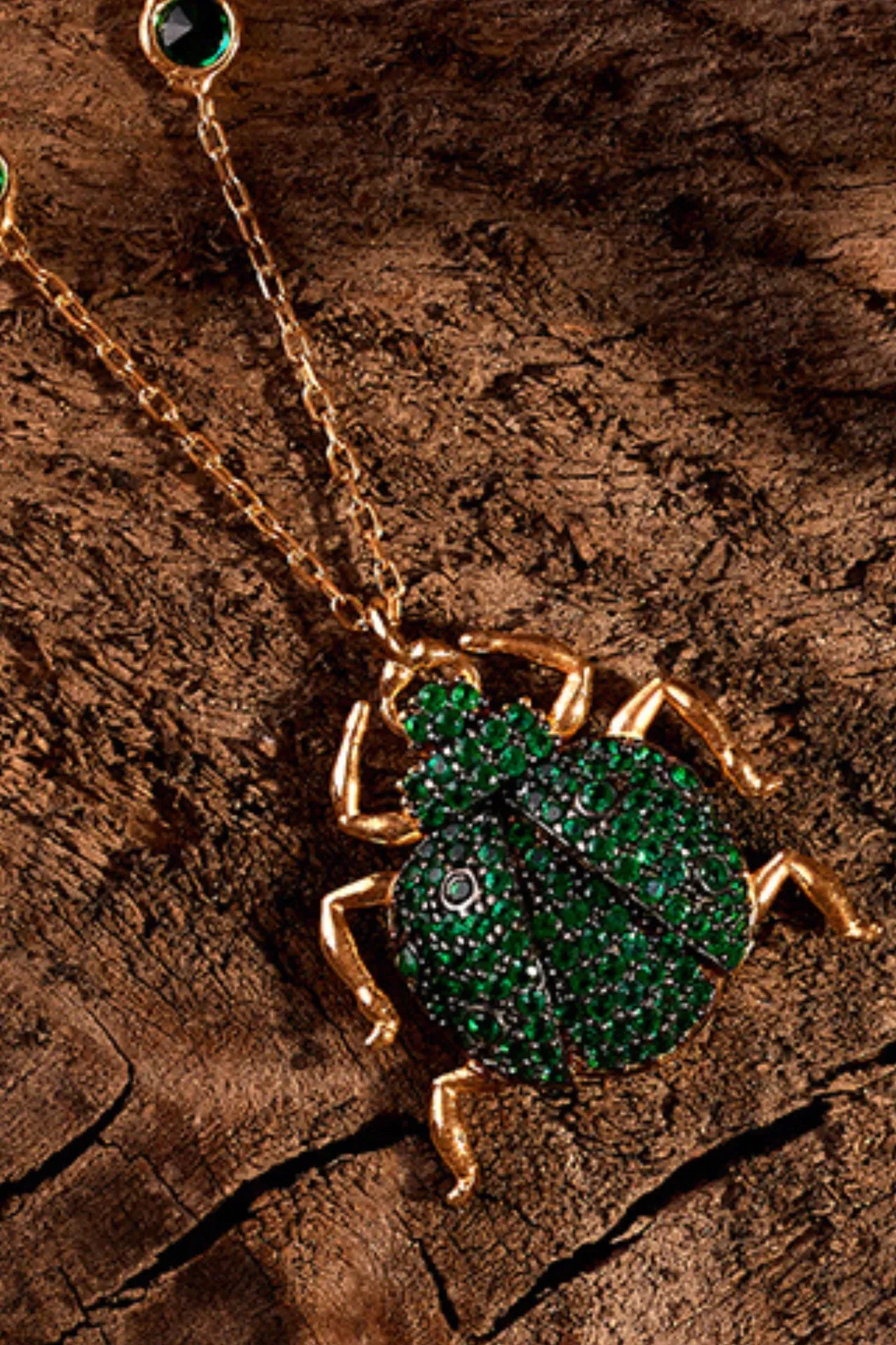 Scarab Beetle Egyptian Green Pendant Necklace Gold worn by a model, showing the pendant scale and how the chain sits.