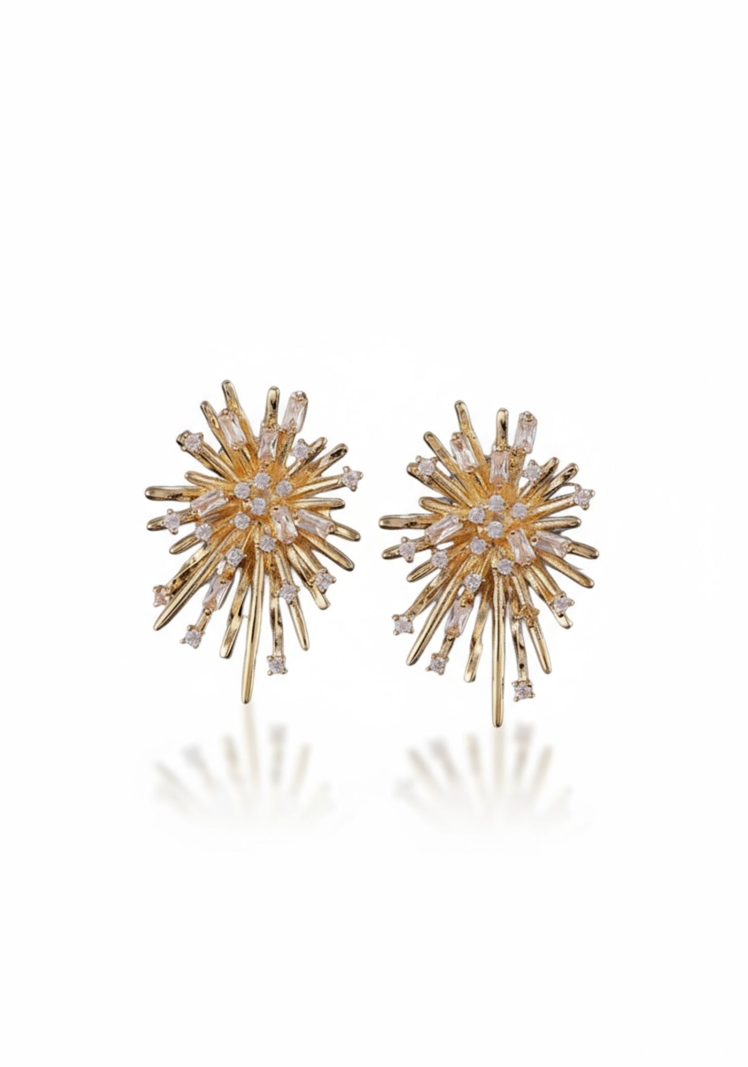Gold starburst stud earrings.