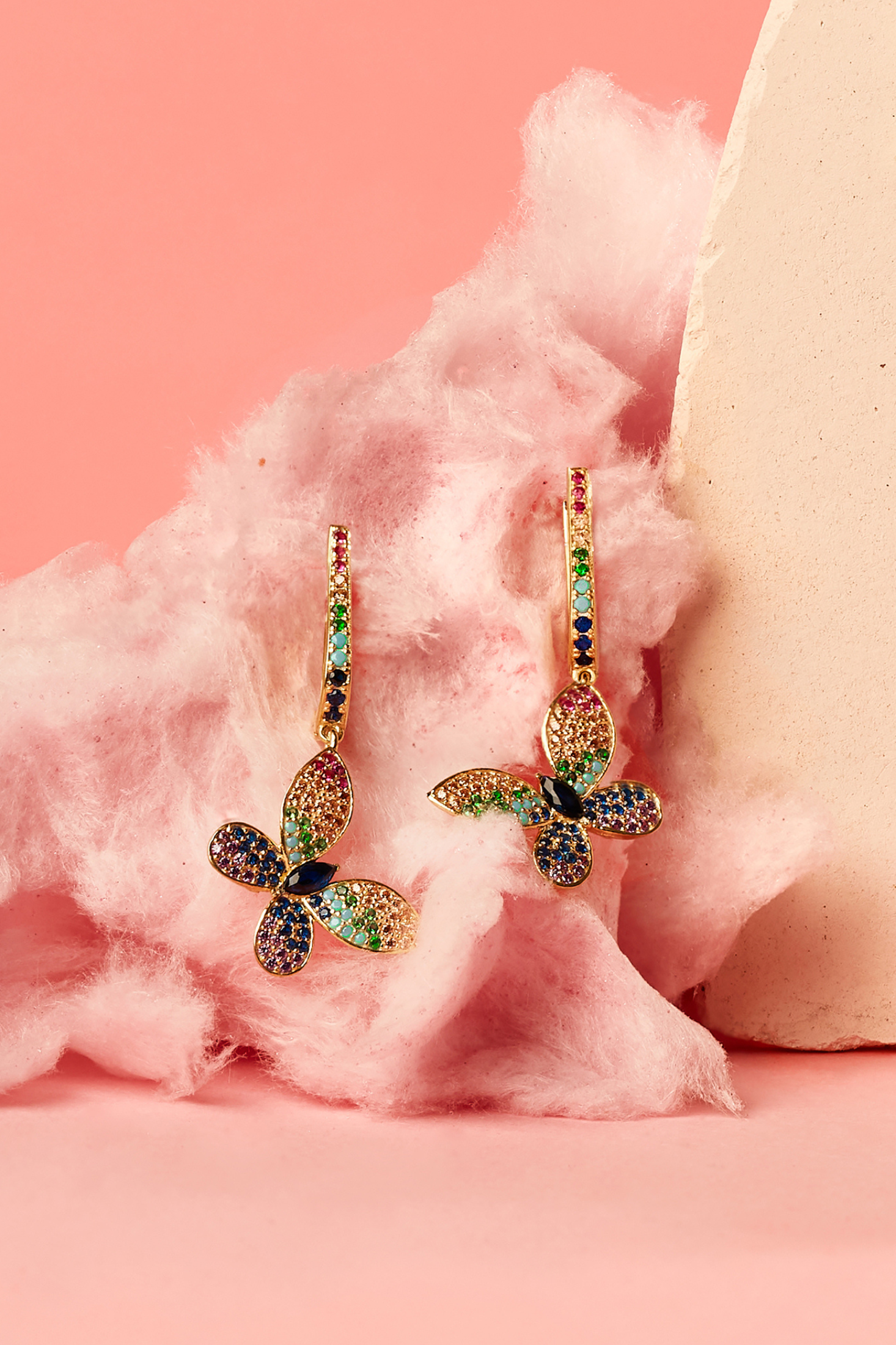 Butterfly Rainbow Multi Coloured Drop Earring Gold worn by a model, showing how they sit on the ear and their scale.