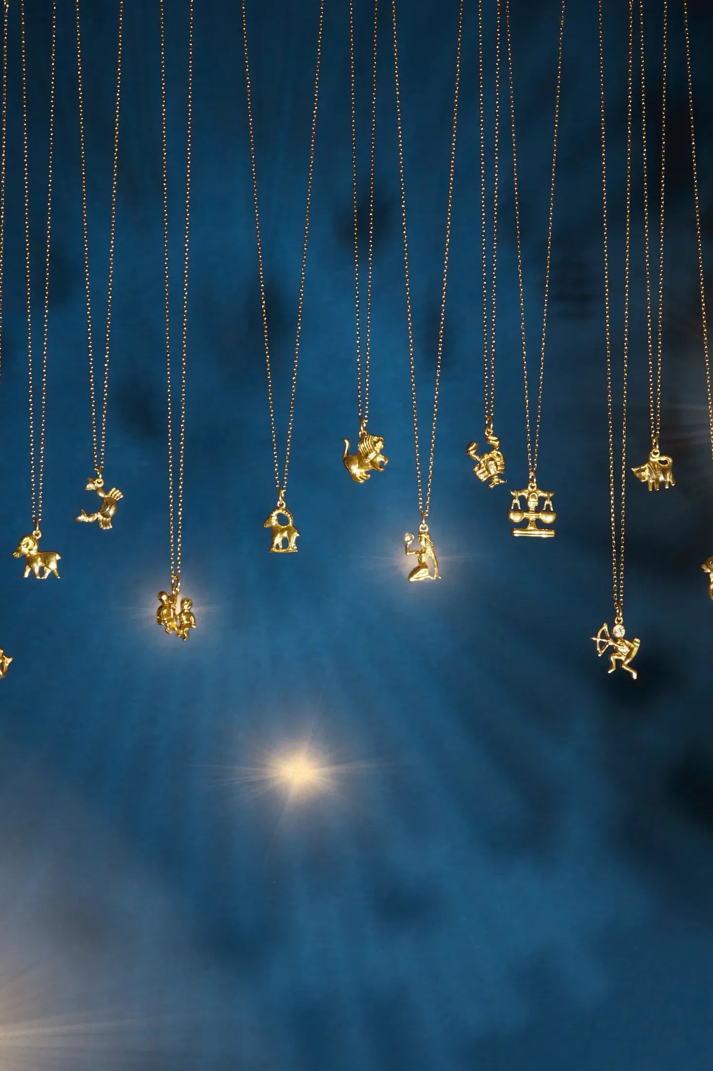 Zodiac Star Sign Necklace Gold Pisces worn by a model, showing the pendant scale and how the chain sits.
