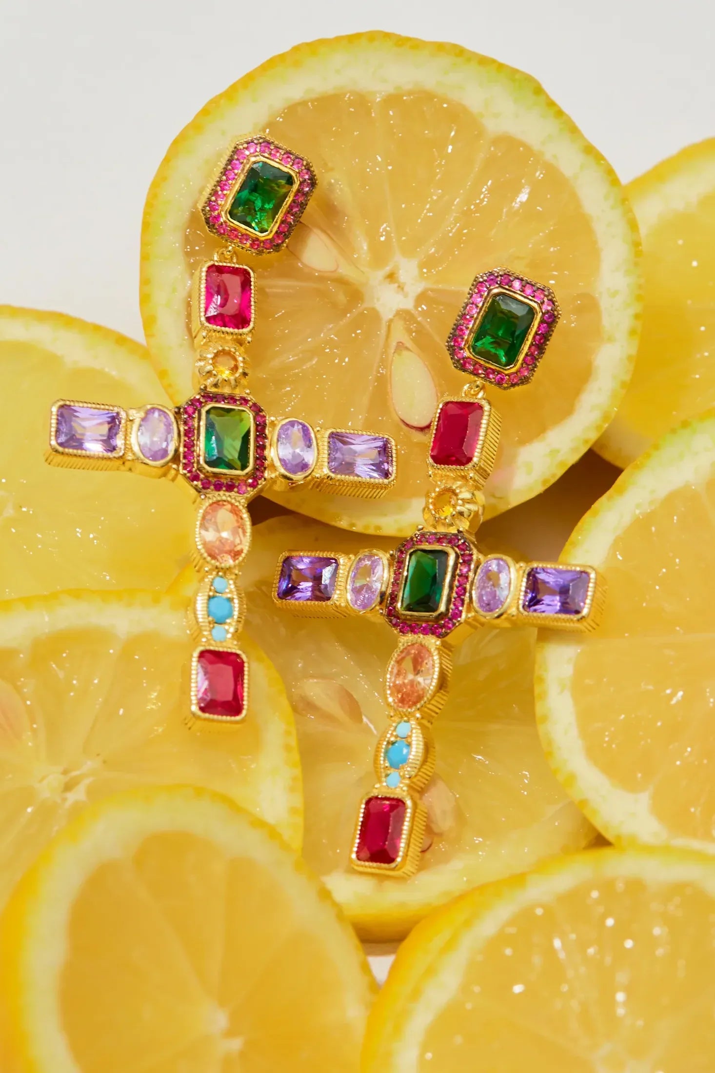 Maria Extra Large Gemstone Fashion Earrings Gold (Cross) worn by a model, showing how they sit on the ear and their scale.