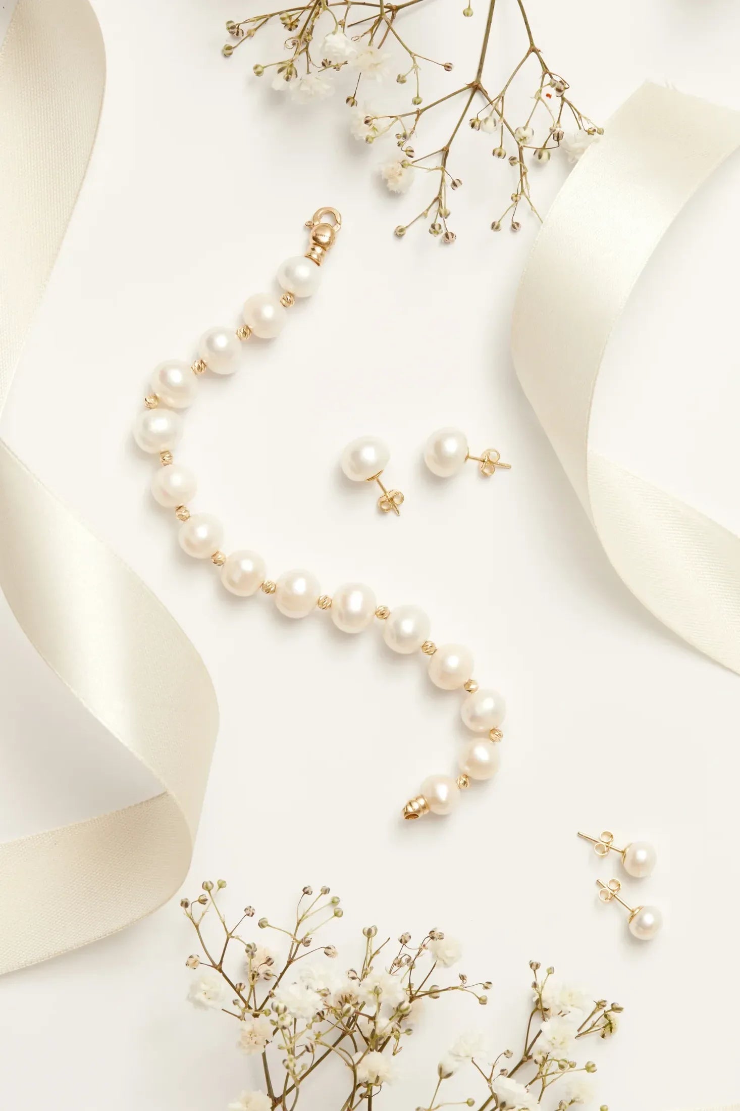 Solid 14K Gold Classic Natural Pearl Bracelet worn by a model, showing how it fits on the wrist and its scale.