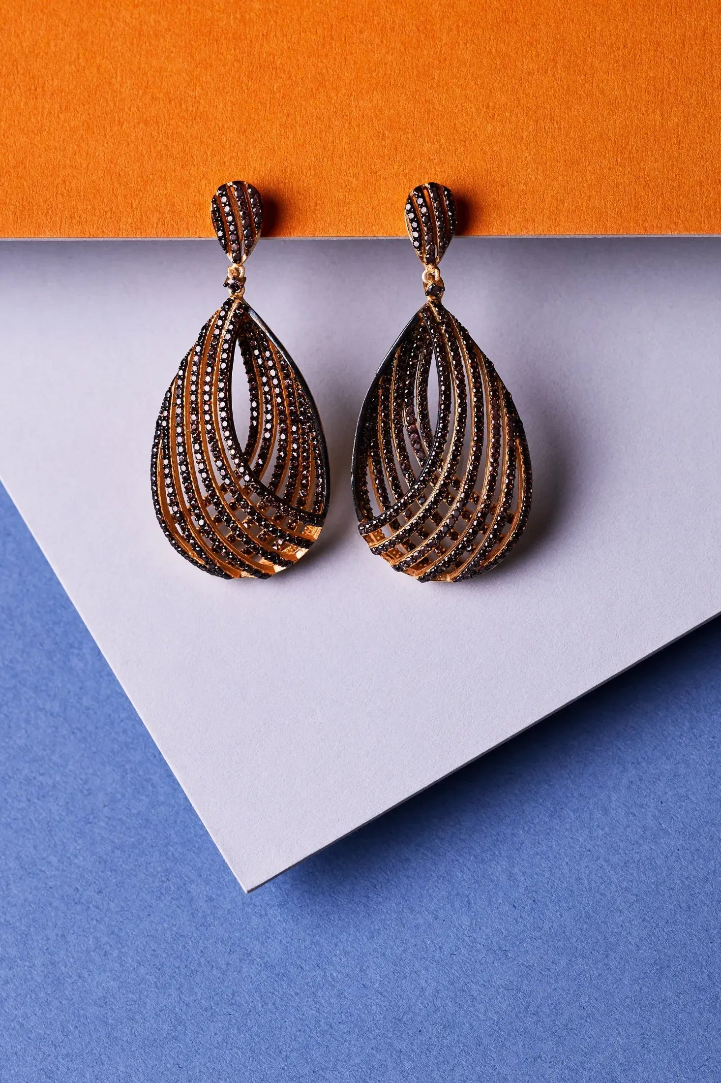 Vortex Teardrop Earring Chocolate Cz worn by a model, showing how they sit on the ear and their scale.
